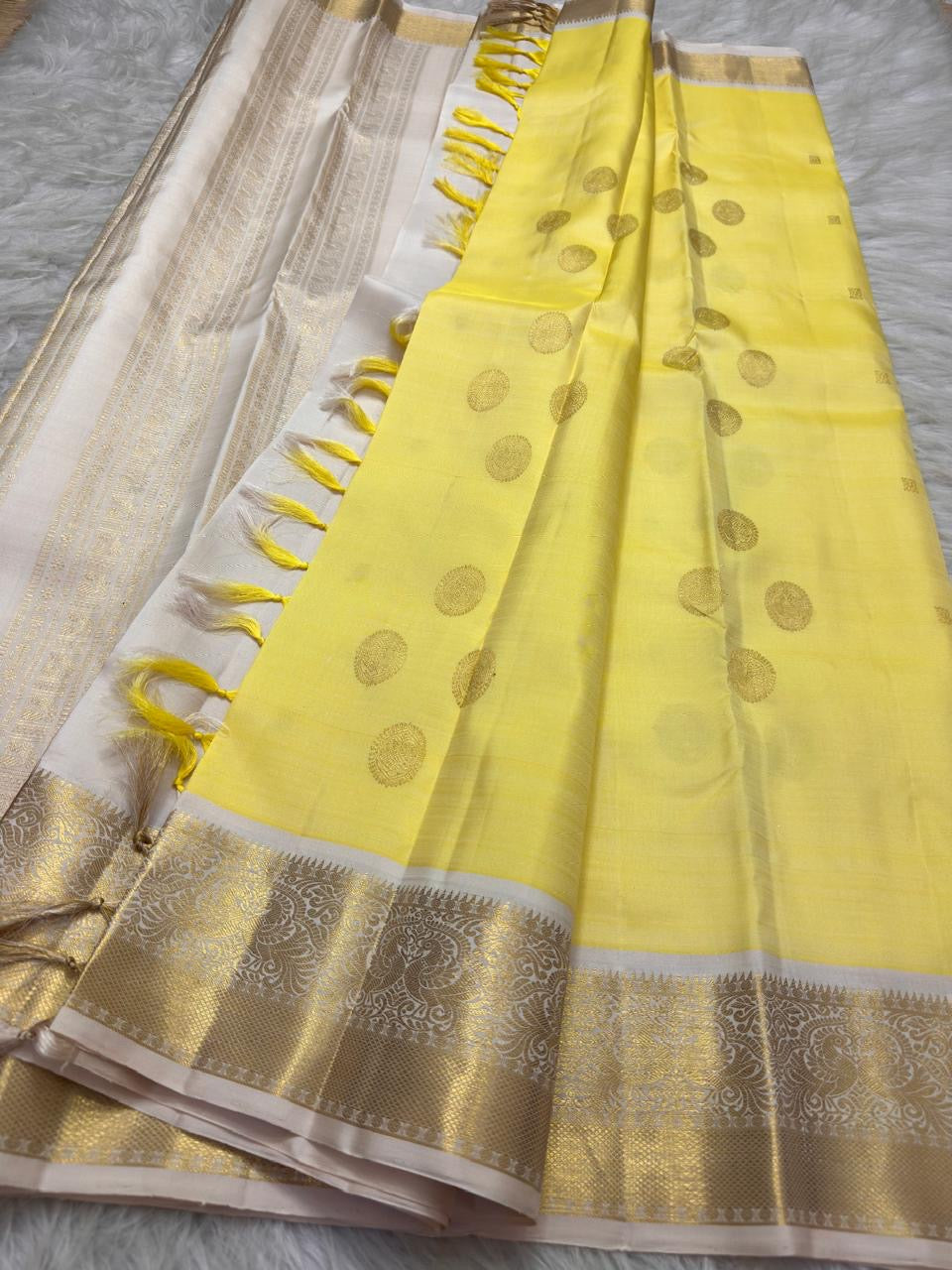 Detailed Kamalam gold-zari buttas on mellow-yellow silk