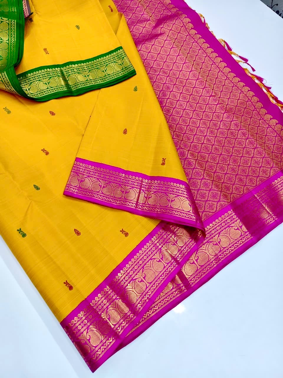 Golden-yellow vintage Ganga Jamuna Korvai Kanchi Pattu saree with petal-pink and green borders