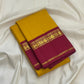 Canary yellow and arakku red Kanjeevaram silk saree folded showing plain body and contrast arakku red Korvai Kaal Irangiya border