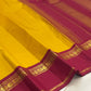 Canary yellow and arakku red handwoven pure silk Kanjeevaram saree with Korvai Kaal Irangiya paisley peacock border overview