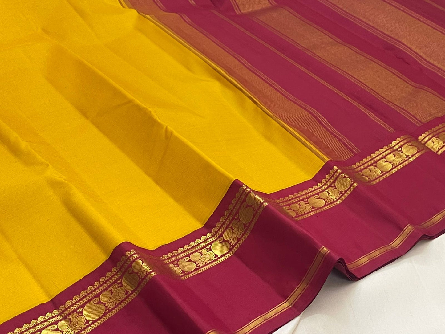 Canary yellow and arakku red handwoven pure silk Kanjeevaram saree with Korvai Kaal Irangiya paisley peacock border overview