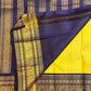 Yellow silk set against navy and gold border with peacock motifs and repeated decorative bands