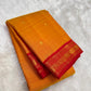 Mango mambazham yellow pure silk Kanchipuram saree folded view with subtle antique gold butta and red border
