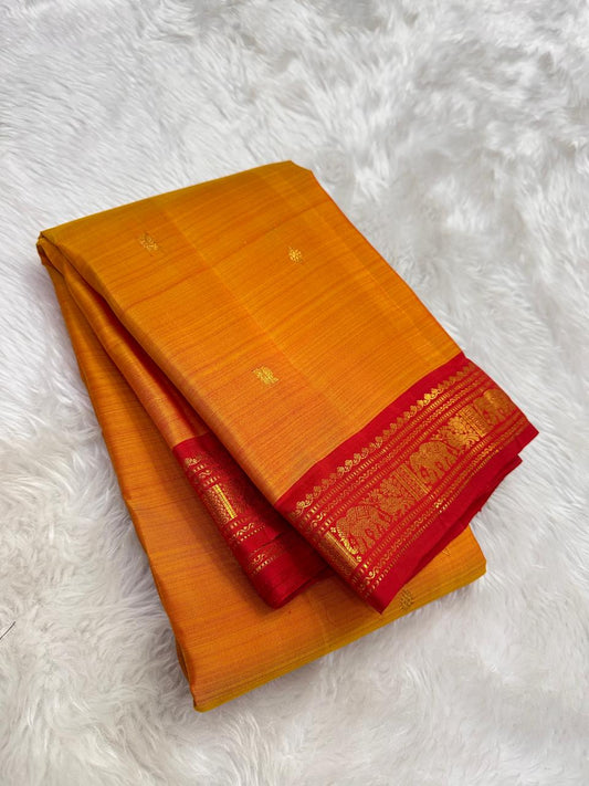 Mango mambazham yellow pure silk Kanchipuram saree folded view with subtle antique gold butta and red border