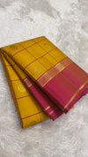 Turmeric yellow Kanjipuram silk saree with rose pink border, full drape