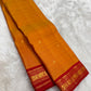 Pure silk Kanchipuram saree in mango mambazham yellow showing body texture and red antique gold zari border