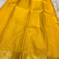 Diagonal zari woven pallu in antique gold cascading across yellow silk ground