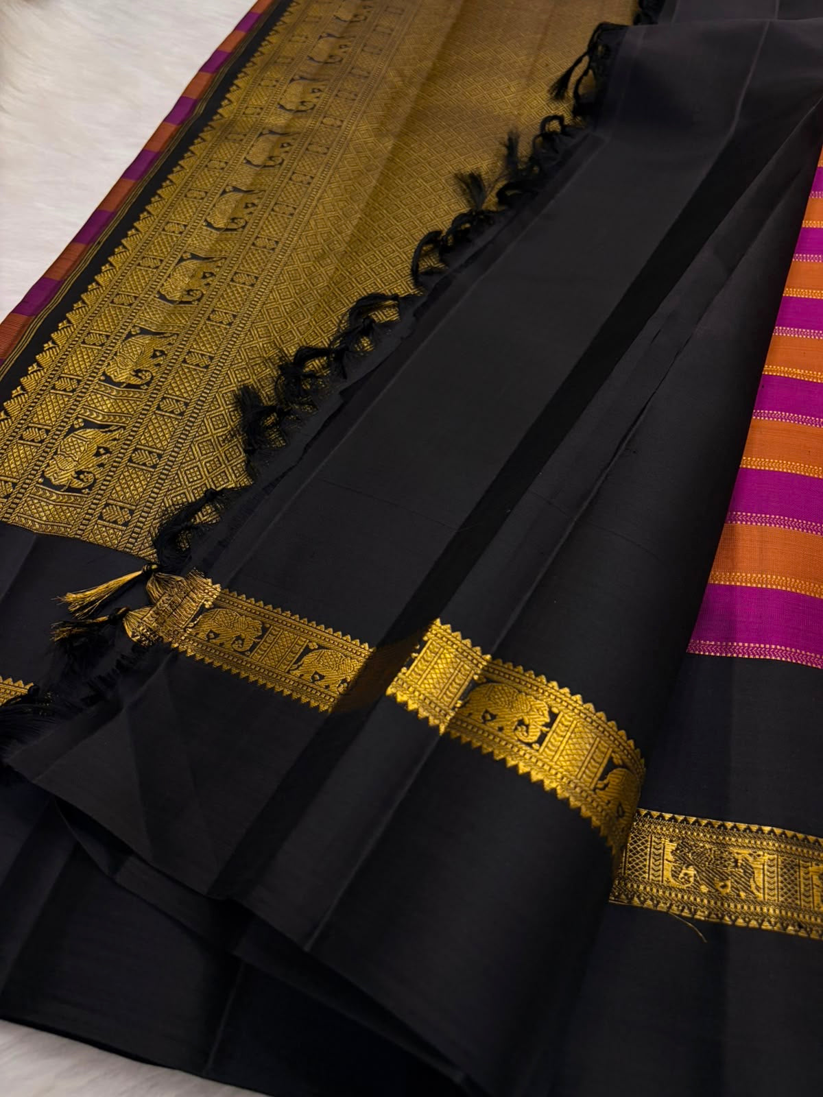 Zari Kattam Kancheepuram saree — antique-gold zari elephant-band border detail