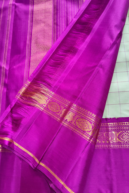 Zari Kattam weave on pale green Kanchipuram silk saree with magenta Korvai Kamalam border — body close-up